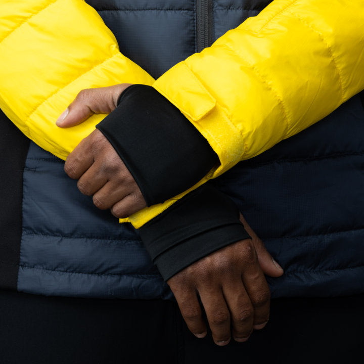 Men's EcoDown Jacket in yellow, made from recycled materials, featuring elastic hems and built-in sleeve gloves.