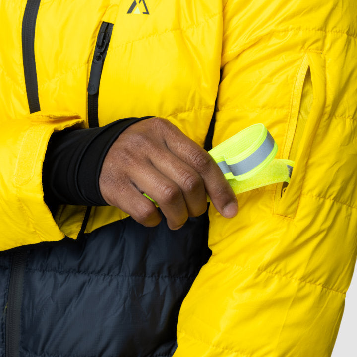 Men's EcoDown Jacket in yellow, made from recycled materials, featuring elastic hems and built-in sleeve gloves.