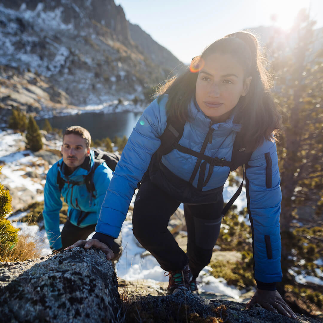 EcoDown Jacket for women in blue, featuring a lightweight design and built-in sleeve gloves for added warmth.