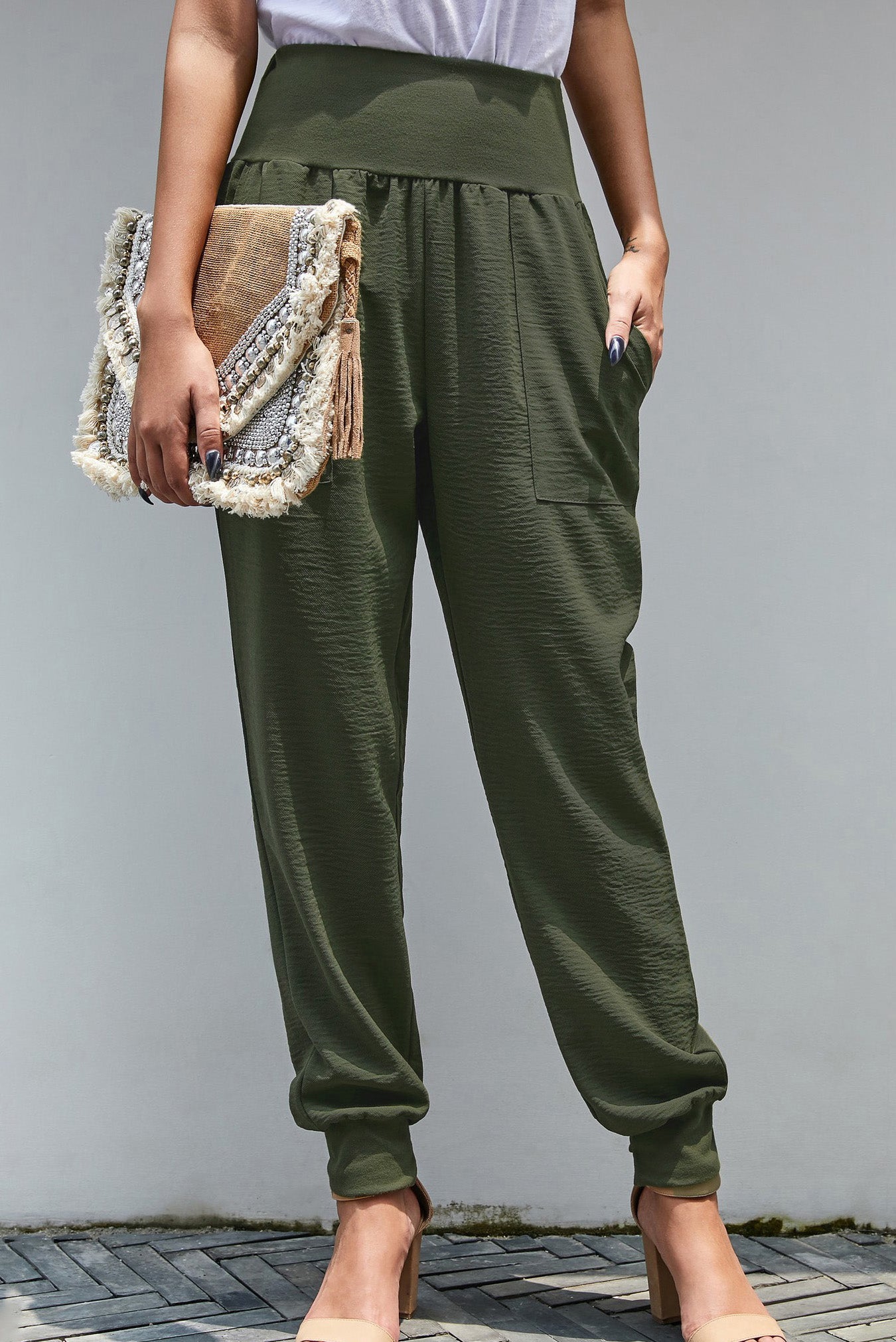 Green Pocketed Stretchy High Waistband Cotton Joggers featuring a billowy harem style silhouette and tapered hem with side slits.