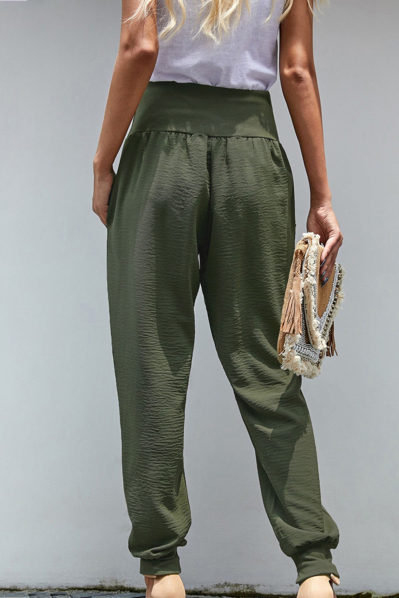 Green Pocketed Stretchy High Waistband Cotton Joggers featuring a billowy harem style silhouette and tapered hem with side slits.