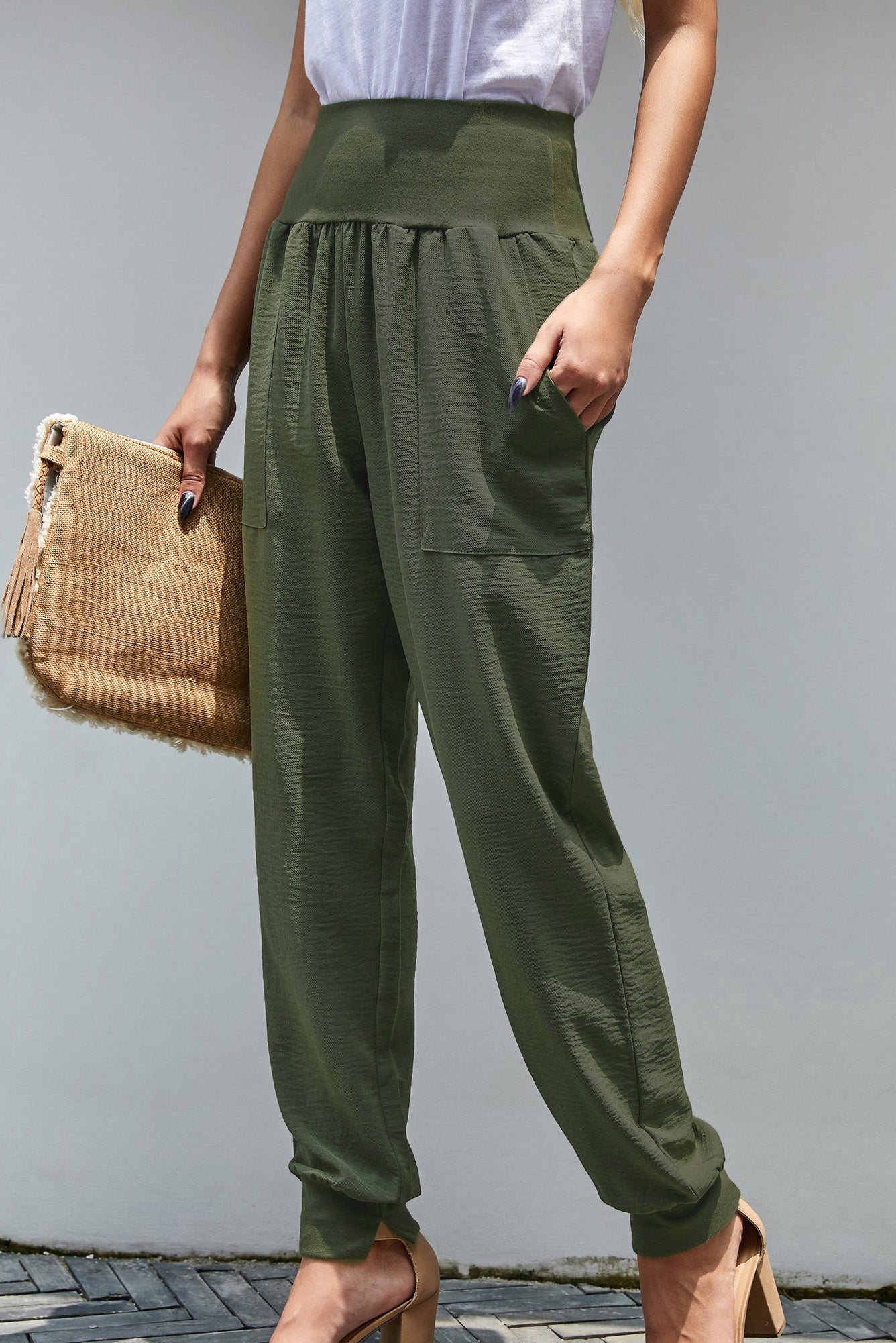 Green Pocketed Stretchy High Waistband Cotton Joggers featuring a billowy harem style silhouette and tapered hem with side slits.