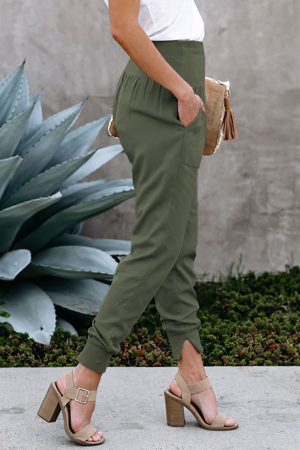 Green Pocketed Stretchy High Waistband Cotton Joggers featuring a billowy harem style silhouette and tapered hem with side slits.