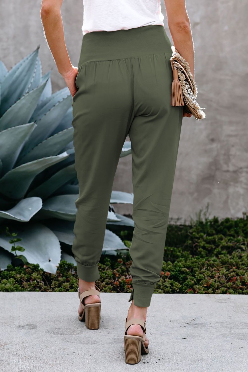 Green Pocketed Stretchy High Waistband Cotton Joggers featuring a billowy harem style silhouette and tapered hem with side slits.