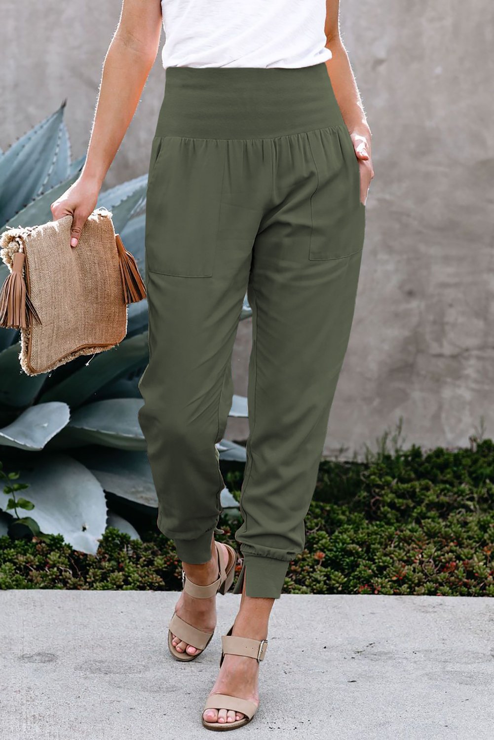 Green Pocketed Stretchy High Waistband Cotton Joggers featuring a billowy harem style silhouette and tapered hem with side slits.