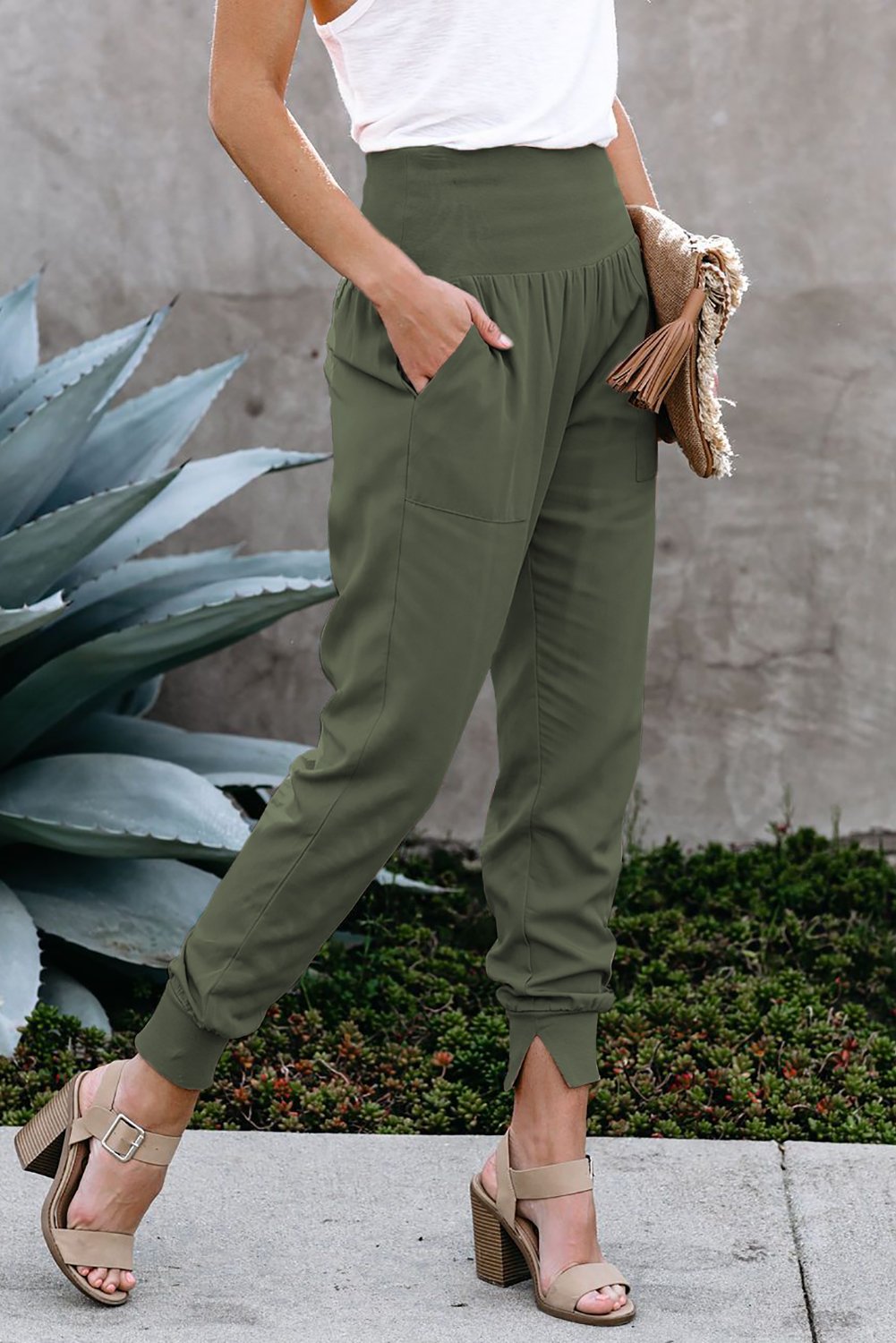 Green Pocketed Stretchy High Waistband Cotton Joggers featuring a billowy harem style silhouette and tapered hem with side slits.