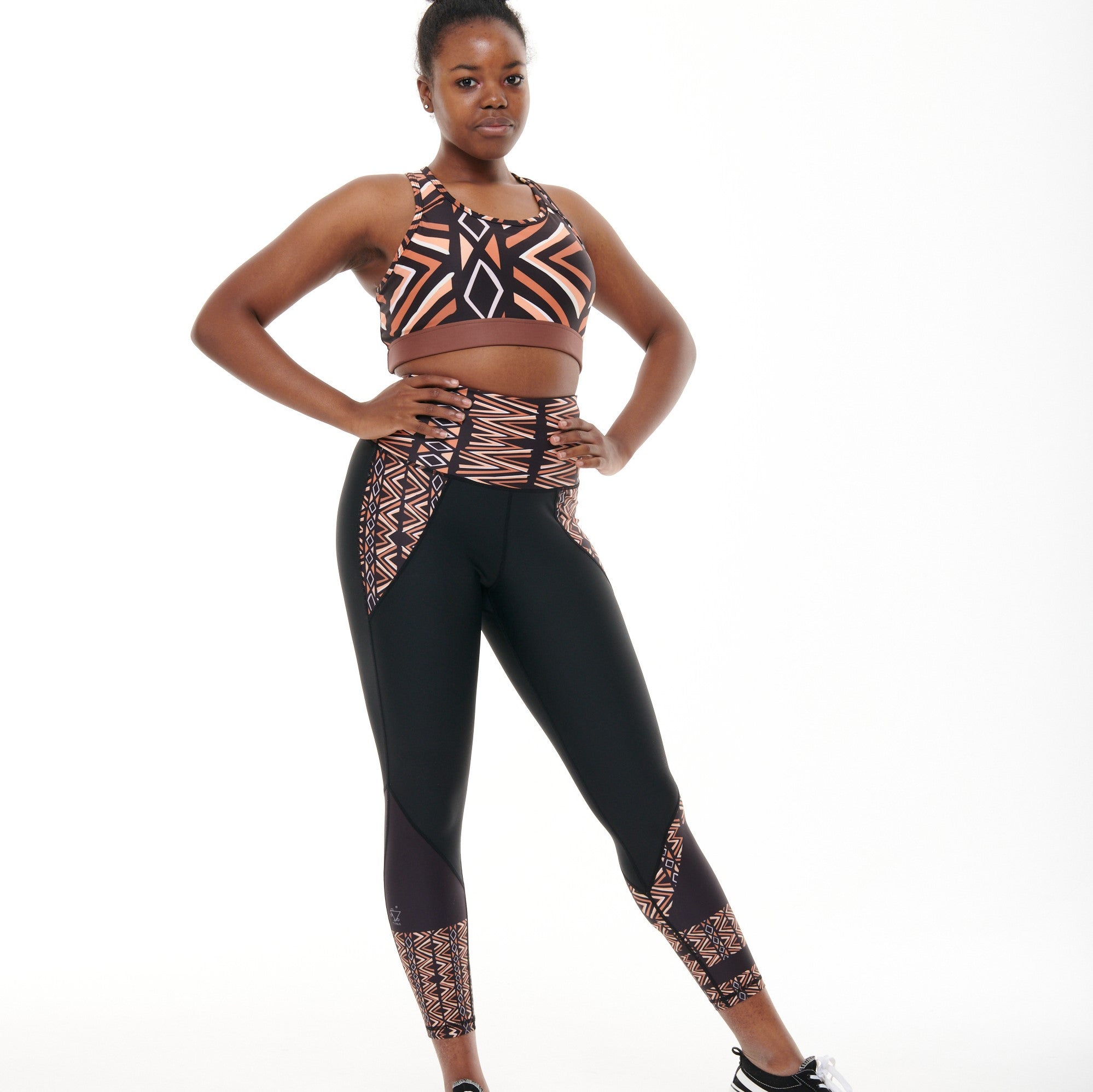 Ibeekay Butiful Leggings featuring a unique Bògòlanfini Mud Cloth pattern in rich hues of Brown, Orange, Black, and White.