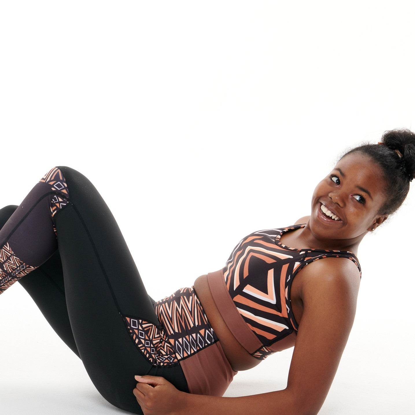 Ibeekay Butiful Leggings featuring a unique Bògòlanfini Mud Cloth pattern in rich hues of Brown, Orange, Black, and White.