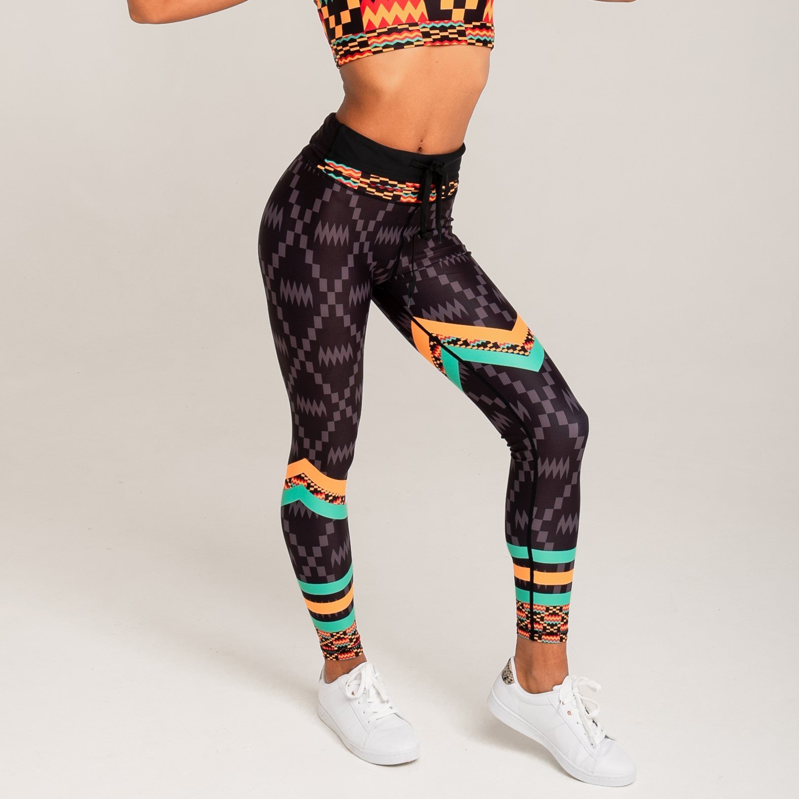 Kayentee Splash Leggings featuring vibrant geometric patterns in black, green, saffron, and flame colors, designed for comfort and style.