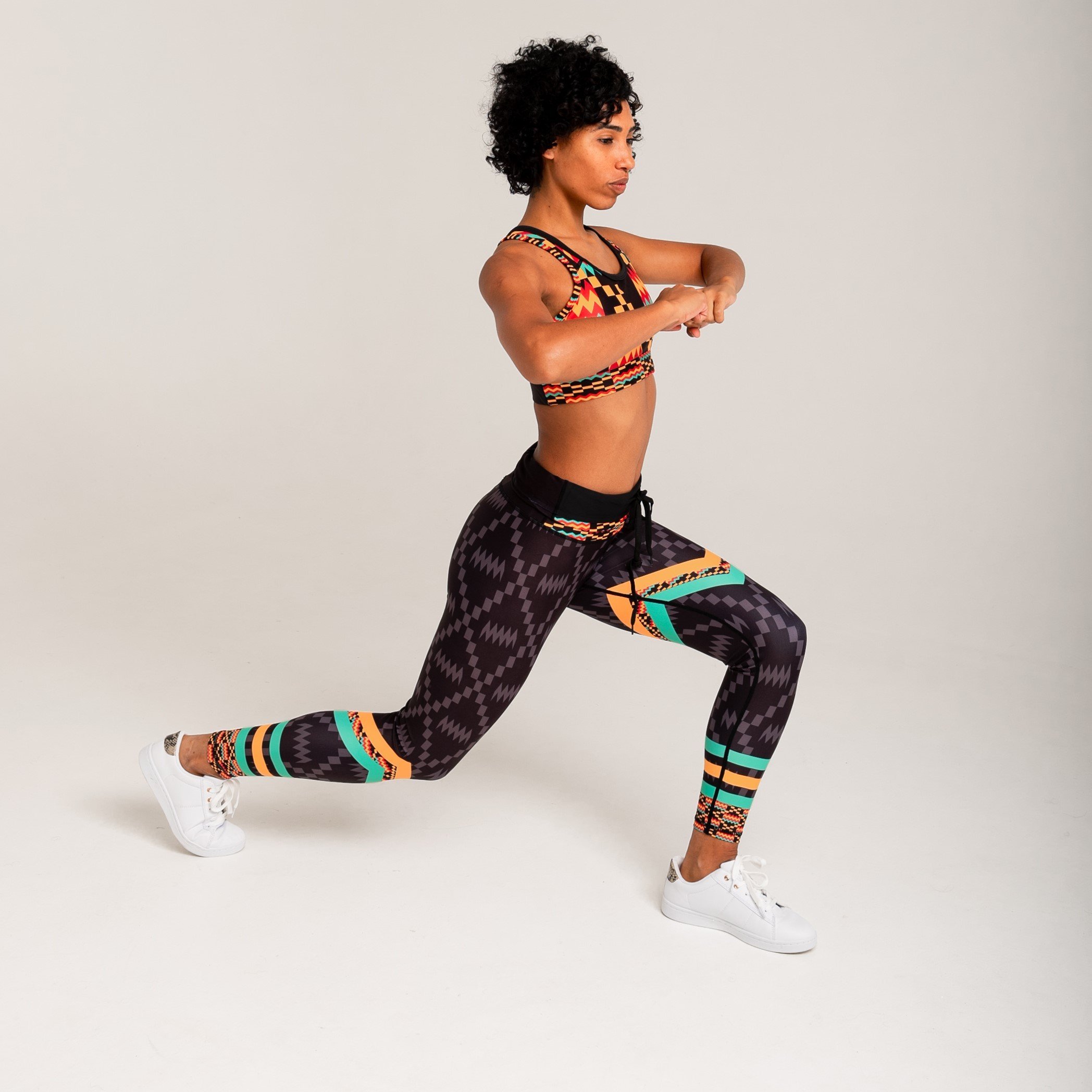 Kayentee Splash Leggings featuring vibrant geometric patterns in black, green, saffron, and flame colors, designed for comfort and style.