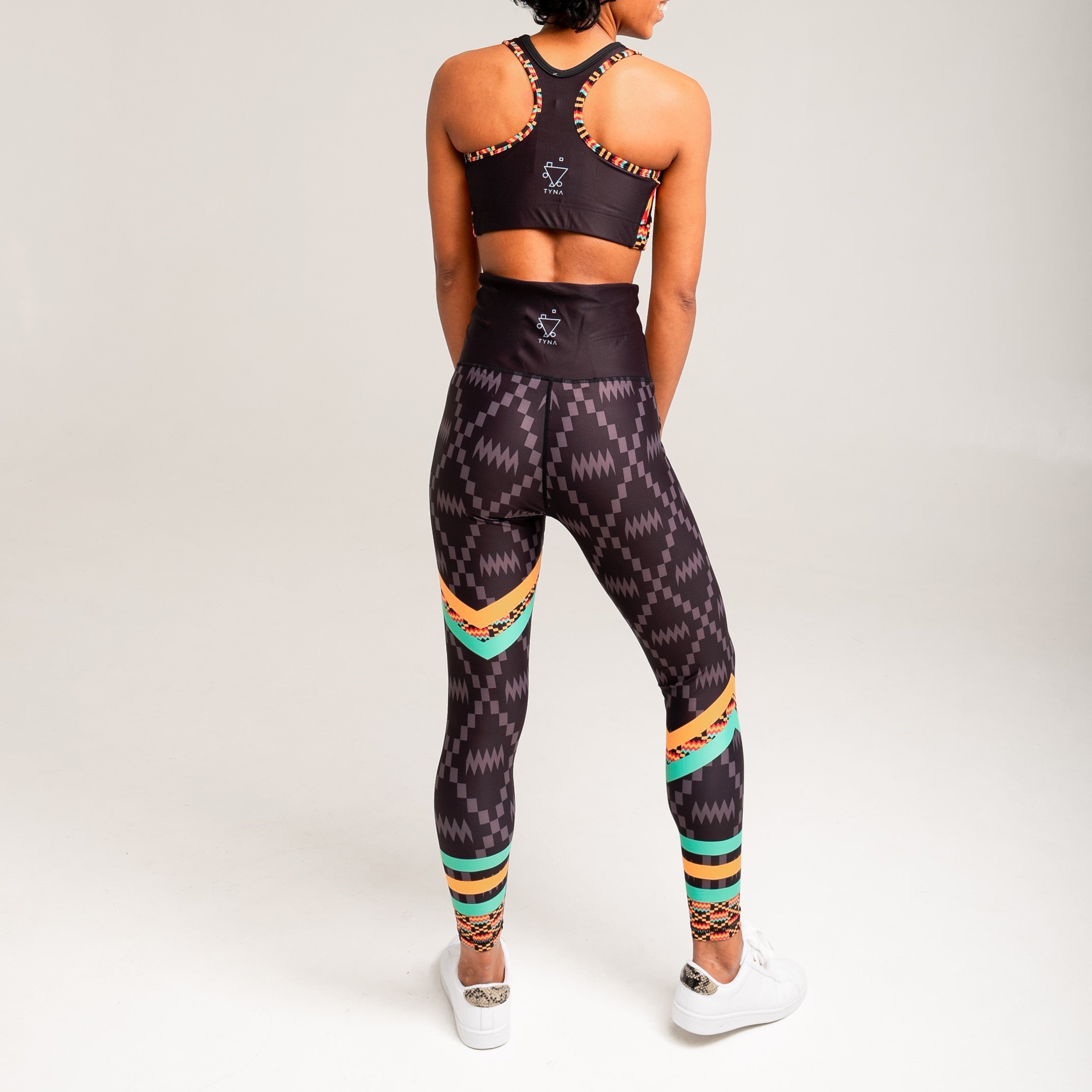 Kayentee Splash Leggings featuring vibrant geometric patterns in black, green, saffron, and flame colors, designed for comfort and style.