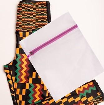 Kayentee Vibrant Leggings featuring bold geometric Kente cloth pattern in black, green, saffron, and flame colors, designed for comfort and performance.