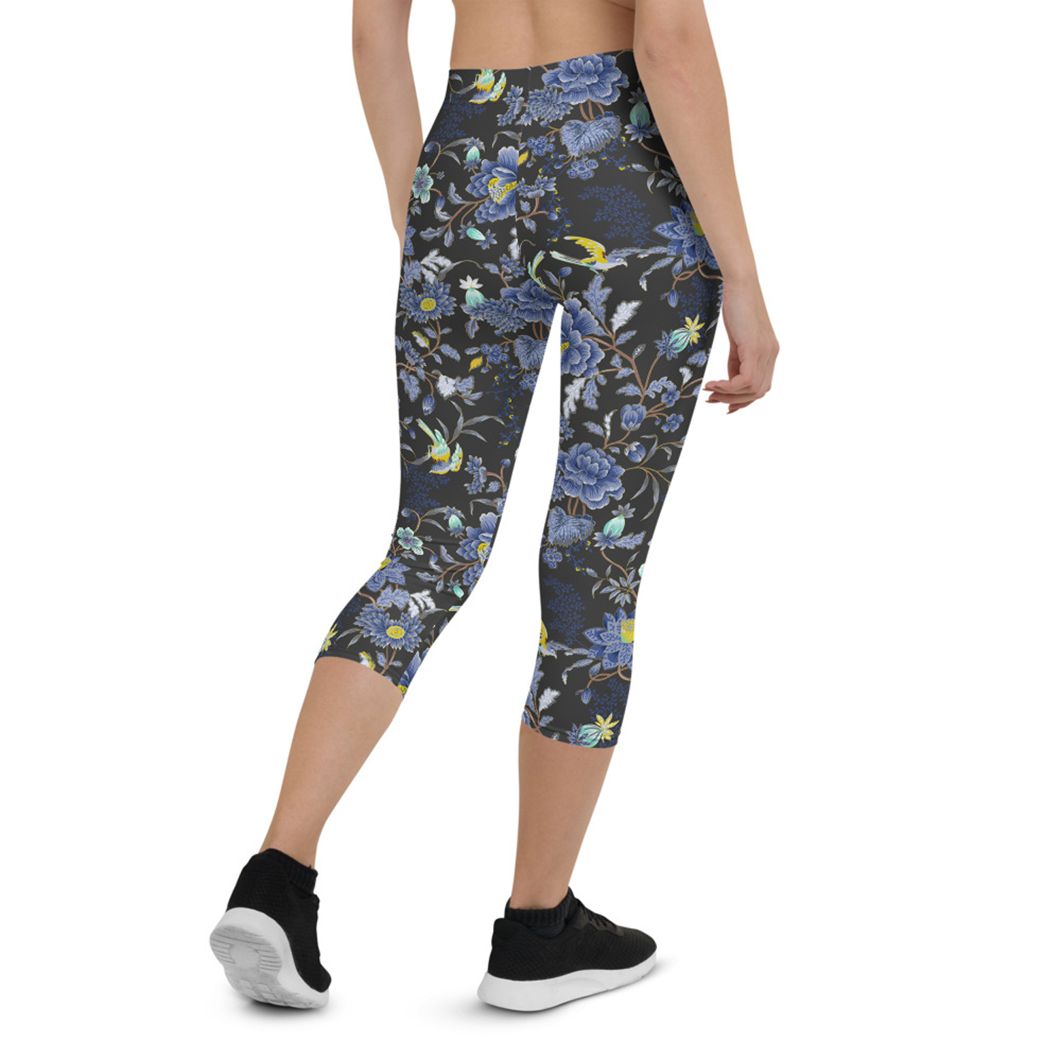 A pair of women's capri leggings featuring an oriental floral design on a dark gray background, showcasing vibrant colors and a stylish fit.