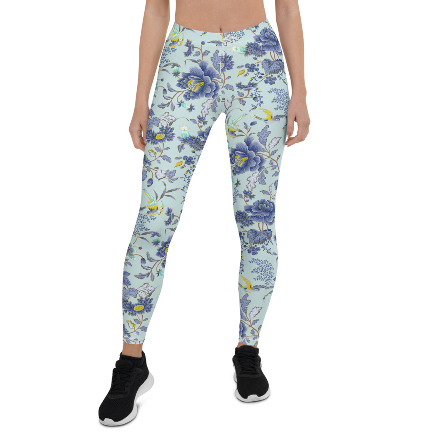 A pair of women's leggings featuring an oriental floral design on a light blue background, showcasing vibrant colors and a stylish fit.