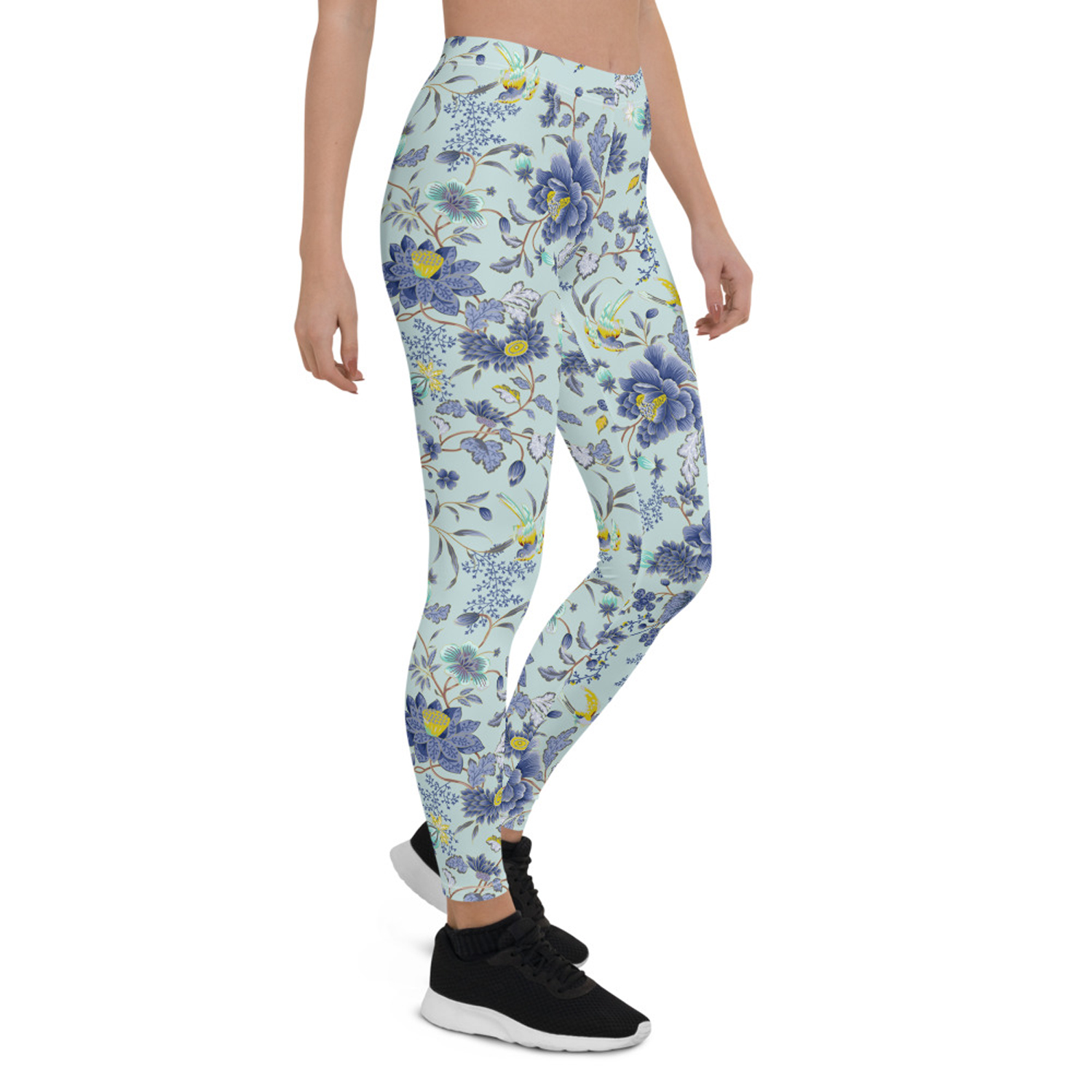 A pair of women's leggings featuring an oriental floral design on a light blue background, showcasing vibrant colors and a stylish fit.