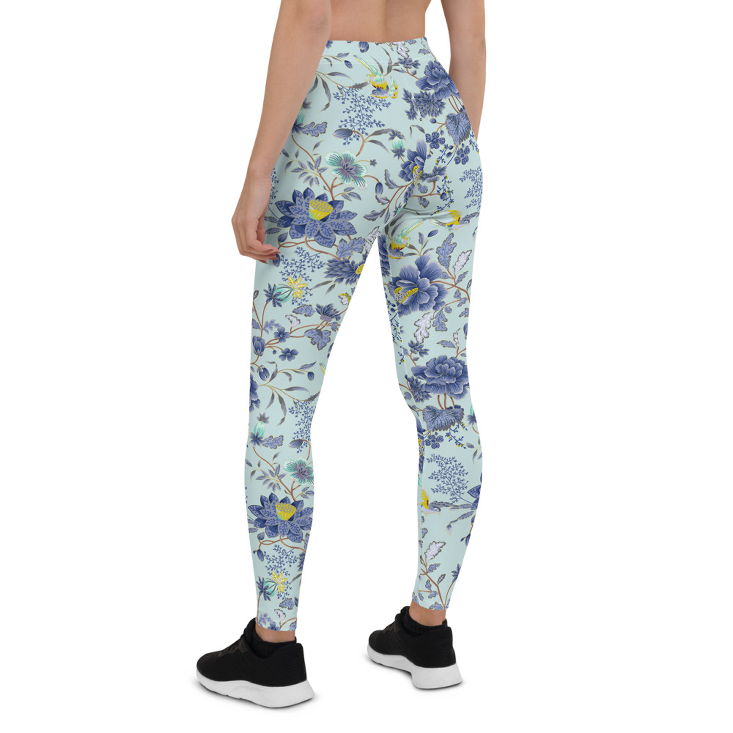 A pair of women's leggings featuring an oriental floral design on a light blue background, showcasing vibrant colors and a stylish fit.