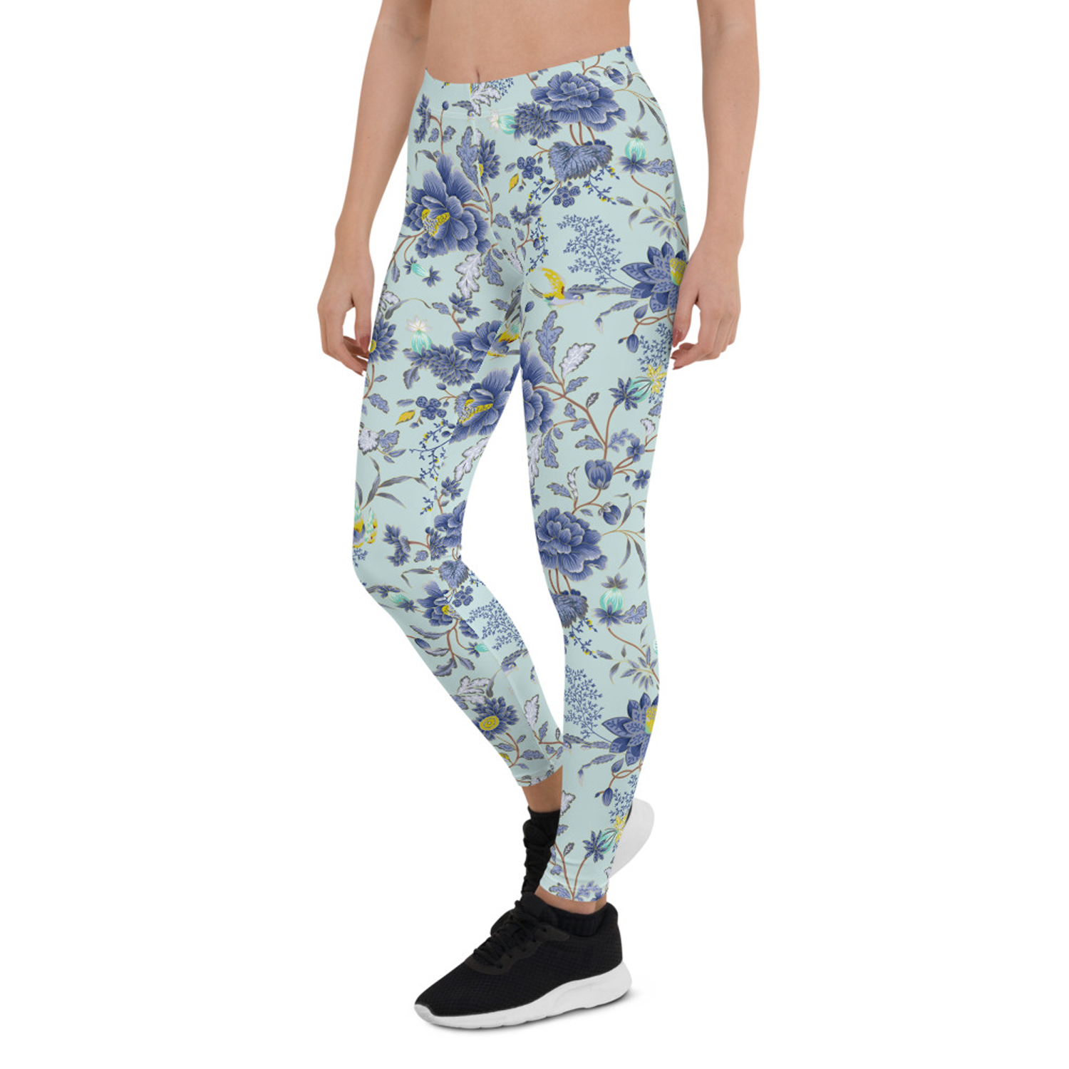 A pair of women's leggings featuring an oriental floral design on a light blue background, showcasing vibrant colors and a stylish fit.