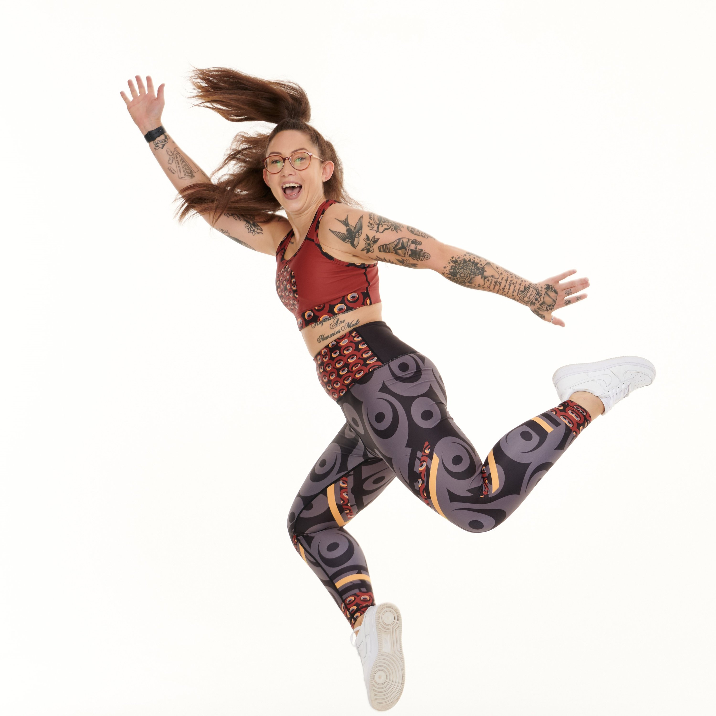 Siefay On Iron Red Splash Leggings featuring vibrant Ankara-inspired patterns in Iron Red, Orange, Black, and Grey.