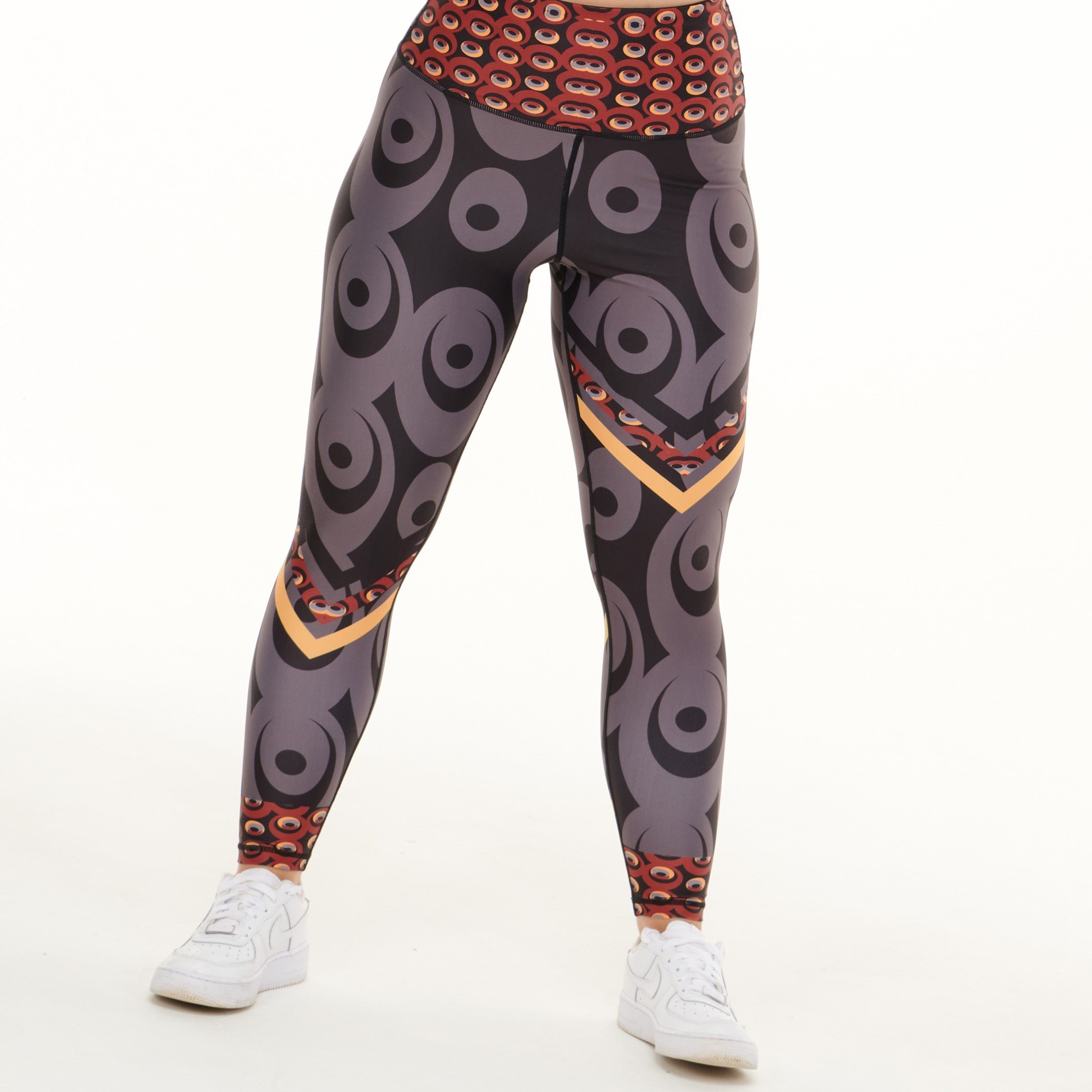 Siefay On Iron Red Splash Leggings featuring vibrant Ankara-inspired patterns in Iron Red, Orange, Black, and Grey.