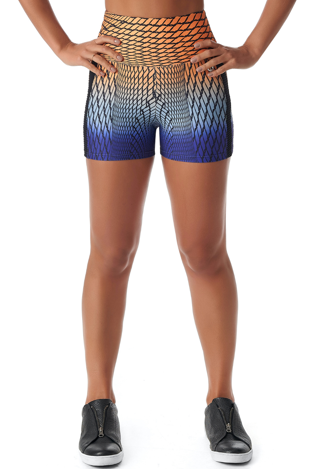 A pair of Spiral Booty Shorts featuring a vibrant abstract pattern, high-waisted design, and soft stretchy material, perfect for active wear.