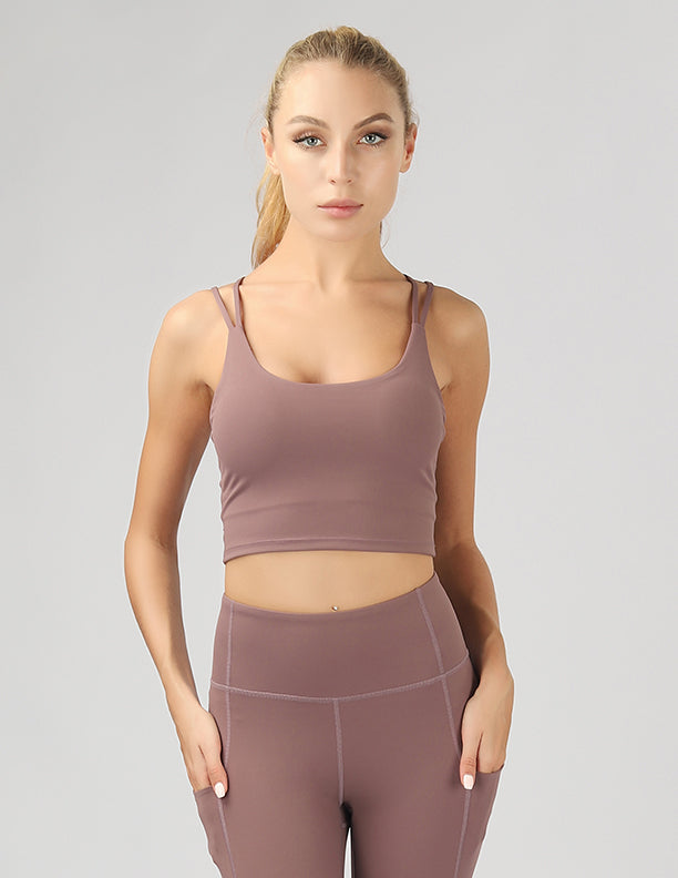 A stylish split shoulder strap crop top featuring a criss-cross back design, made from breathable 4-way stretch fabric.