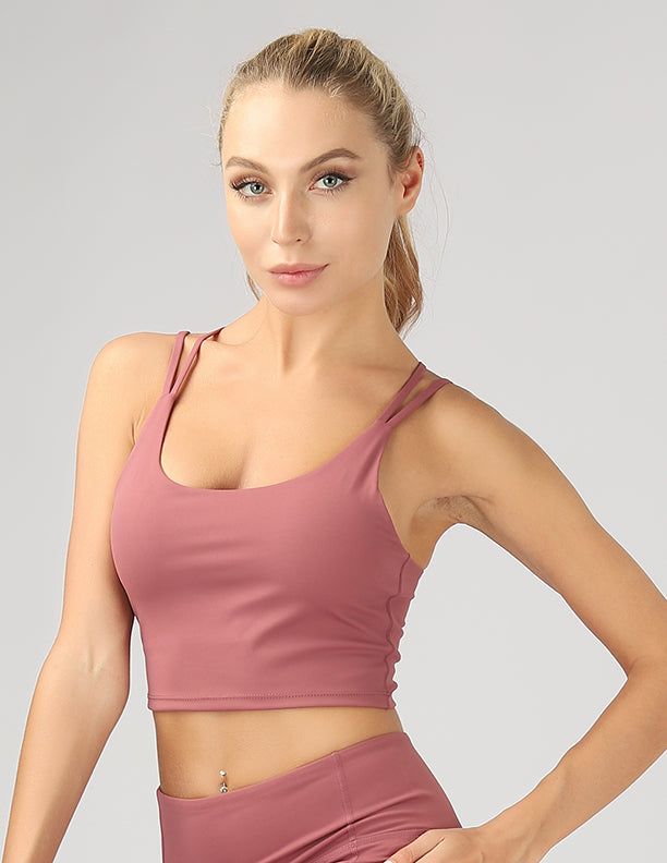 A stylish split shoulder strap crop top featuring a criss-cross back design, made from breathable 4-way stretch fabric.