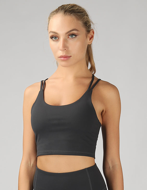 A stylish split shoulder strap crop top featuring a criss-cross back design, made from breathable 4-way stretch fabric.