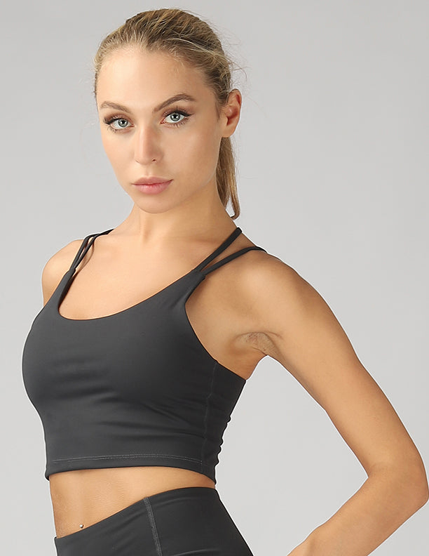 A stylish split shoulder strap crop top featuring a criss-cross back design, made from breathable 4-way stretch fabric.