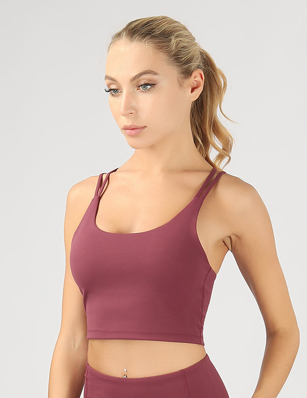 A stylish split shoulder strap crop top featuring a criss-cross back design, made from breathable 4-way stretch fabric.