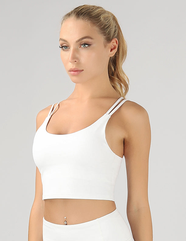 A stylish split shoulder strap crop top featuring a criss-cross back design, made from breathable 4-way stretch fabric.