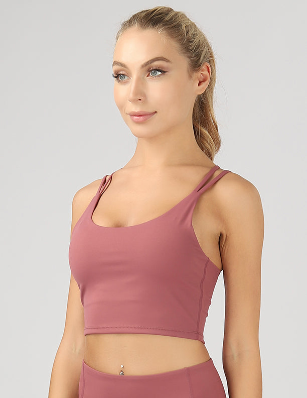 A stylish split shoulder strap crop top featuring a criss-cross back design, made from breathable 4-way stretch fabric.