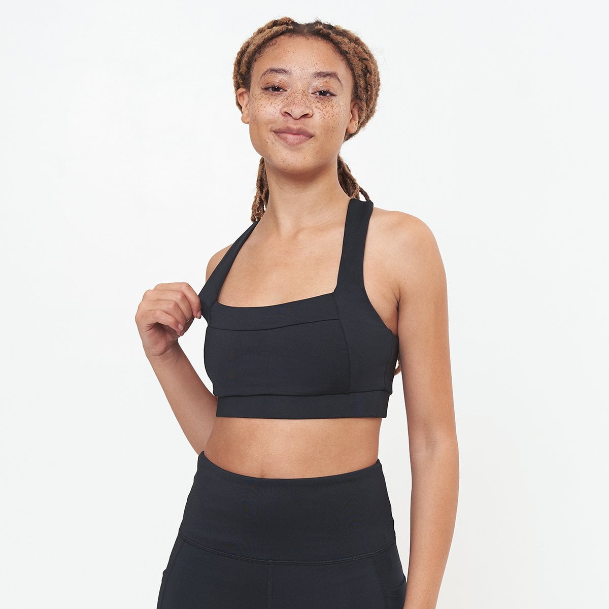 Lola Getts Square Neck Performance Bra in black, showcasing its stylish square neck design and moisture-wicking fabric.