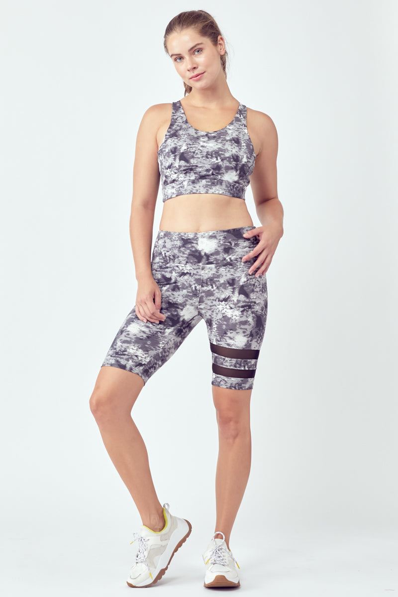 Striped Tie-Dye Biker Set featuring stylish biker shorts and a racerback sports bra with a hollow center.