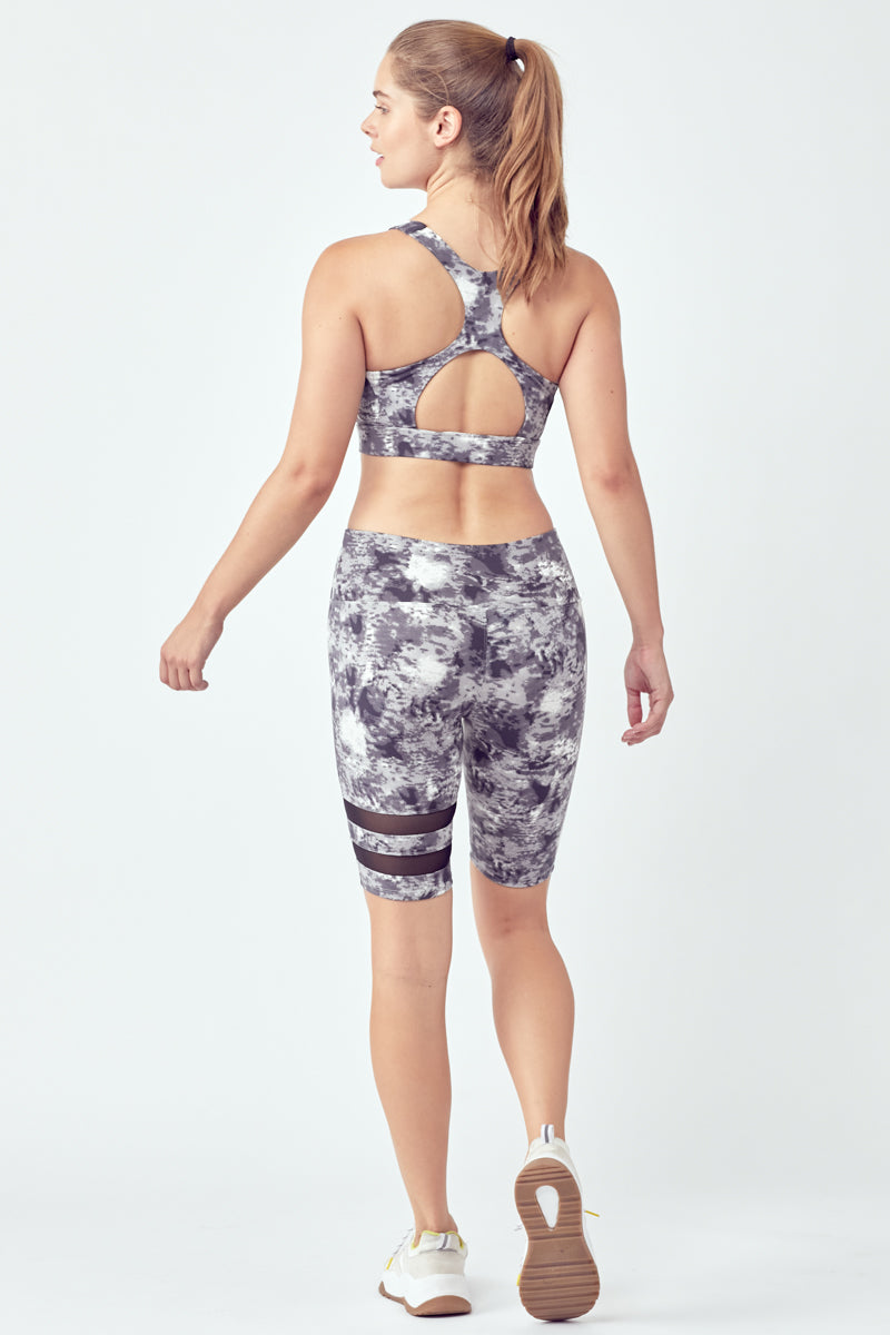 Striped Tie-Dye Biker Set featuring stylish biker shorts and a racerback sports bra with a hollow center.