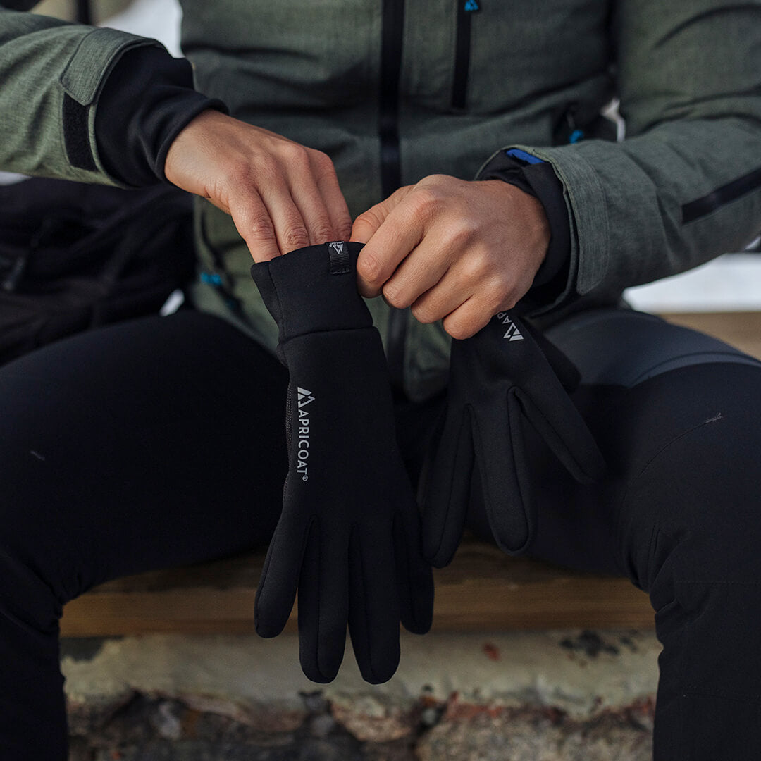 A pair of eco-friendly thermal gloves made from recycled polyester, showcasing their lightweight and stretchy design, perfect for outdoor activities.