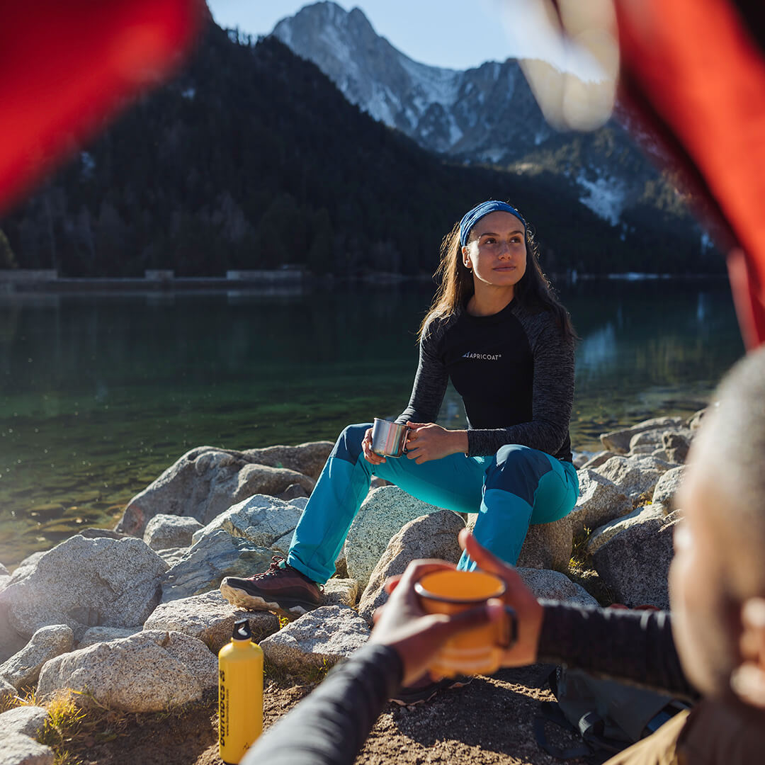 A stylish women's thermal shirt made from eco-friendly recycled polyester, featuring a breathable and stretchy design for comfort and warmth.