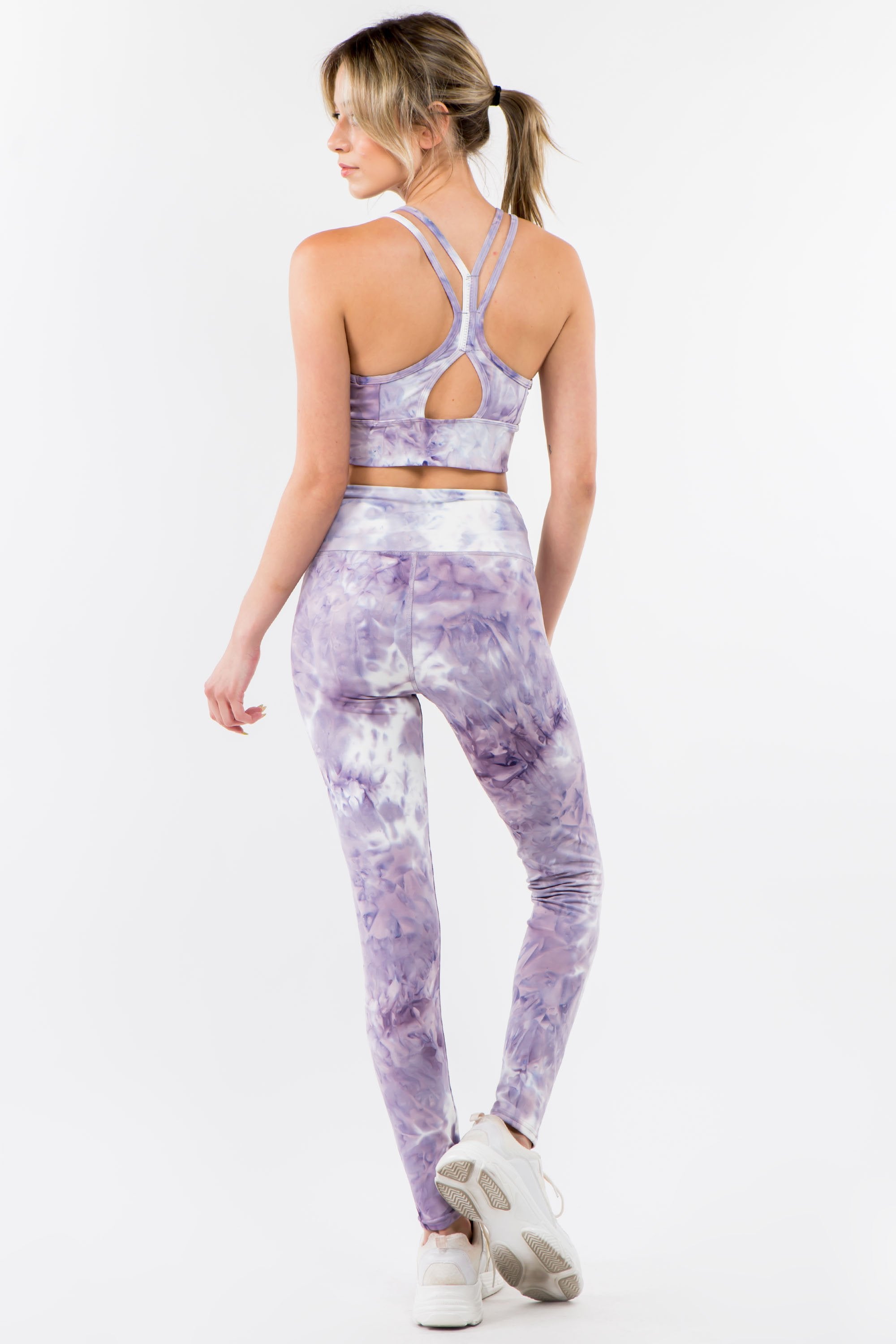 Violet tie-dye activewear set featuring a racerback bra and high-waisted leggings, perfect for workouts and casual wear.