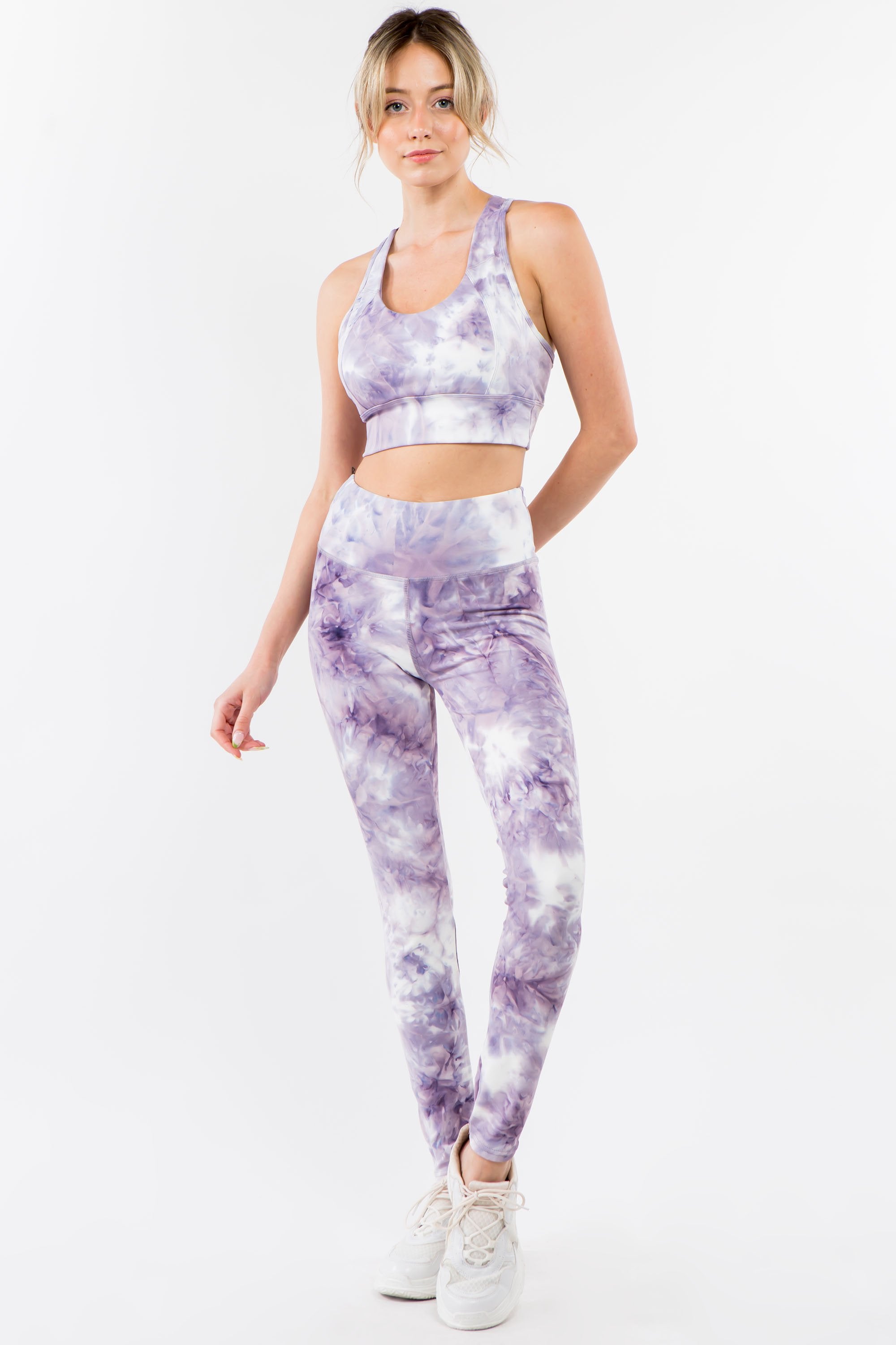 Violet tie-dye activewear set featuring a racerback bra and high-waisted leggings, perfect for workouts and casual wear.