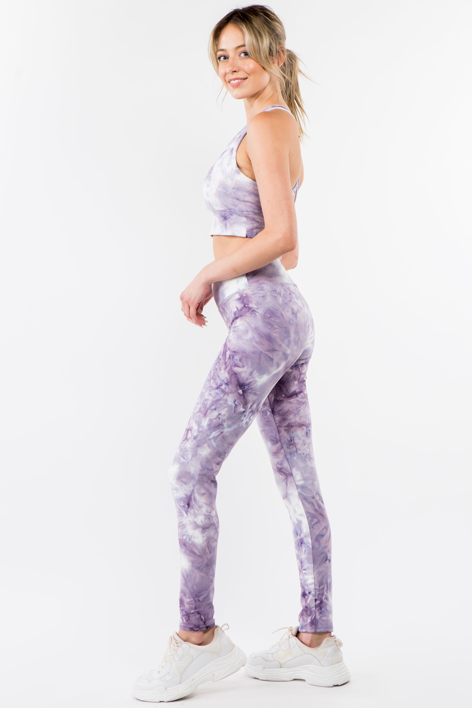 Violet tie-dye activewear set featuring a racerback bra and high-waisted leggings, perfect for workouts and casual wear.