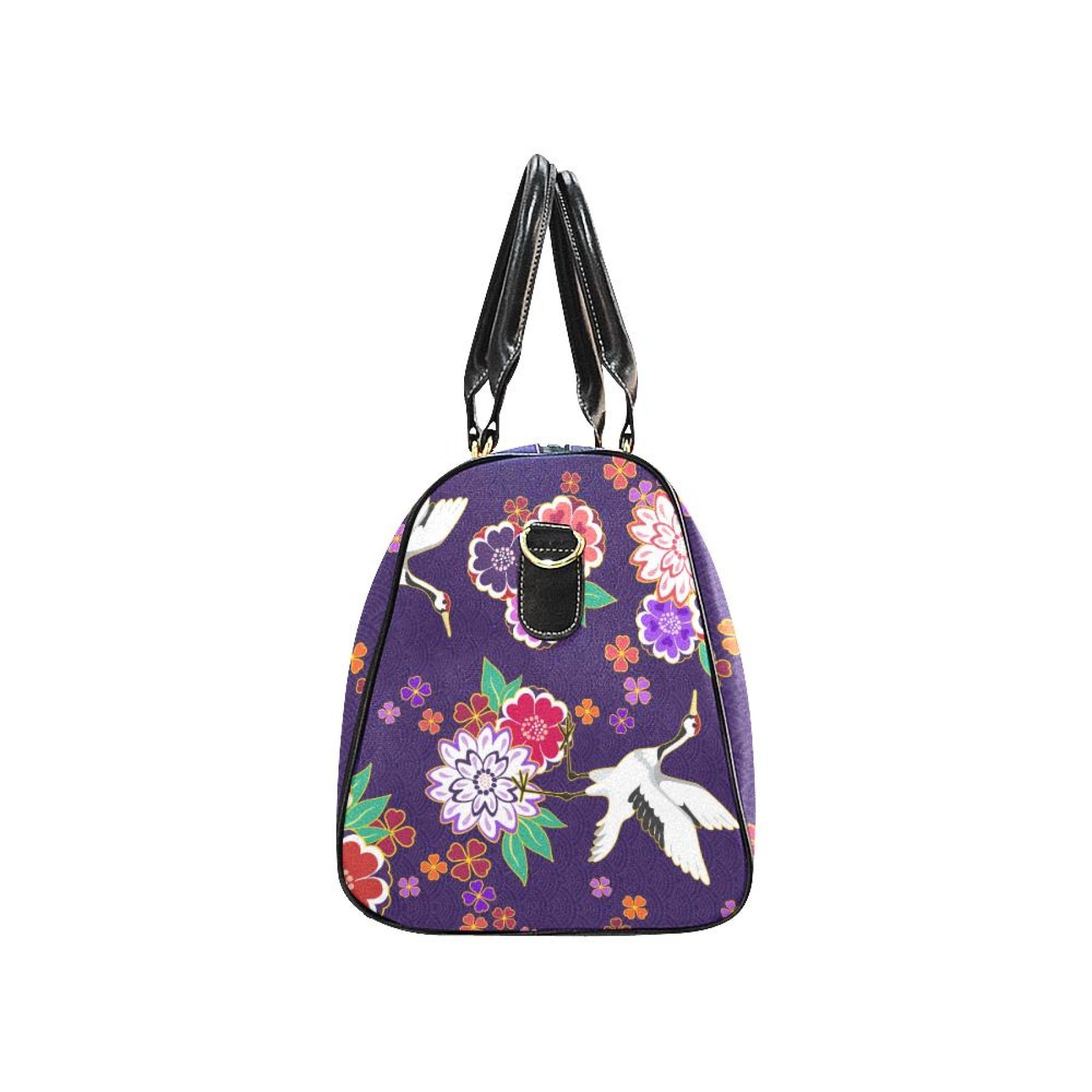 Purple floral travel bag with double handles and adjustable shoulder strap, made from waterproof fabric.