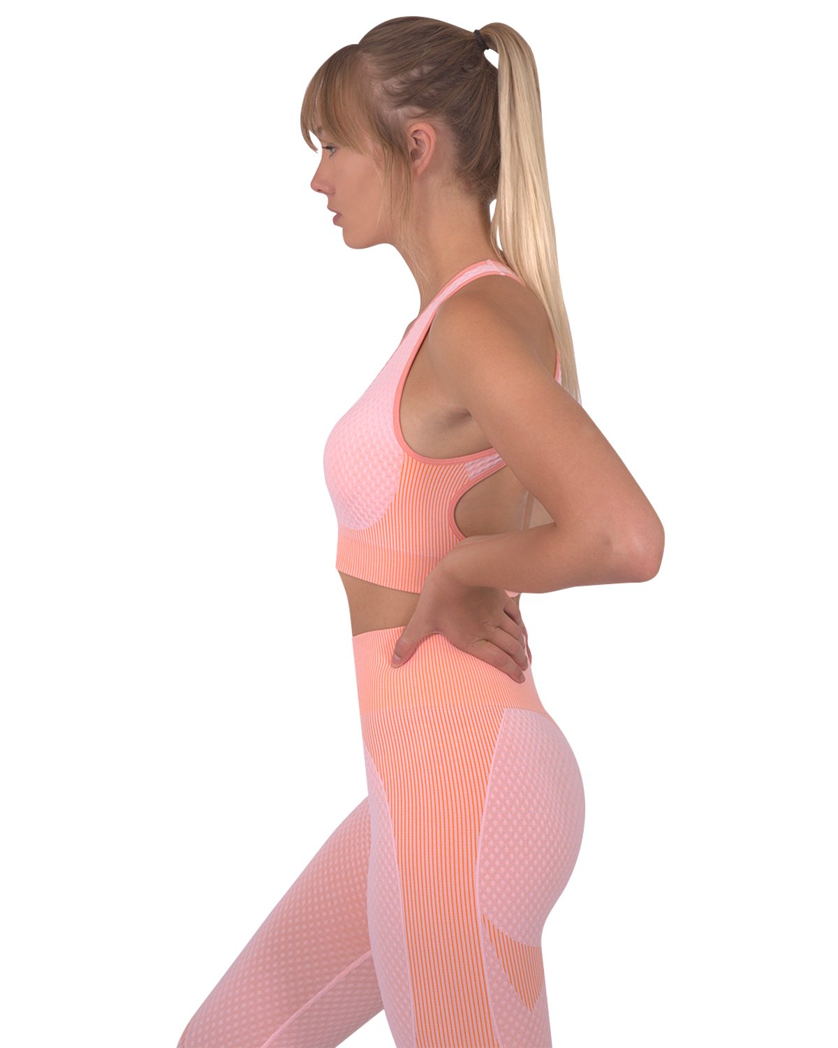 Trois Seamless Sports Bra in pink with orange stripes and cross-over back straps, showcasing its unique design and stylish appearance.