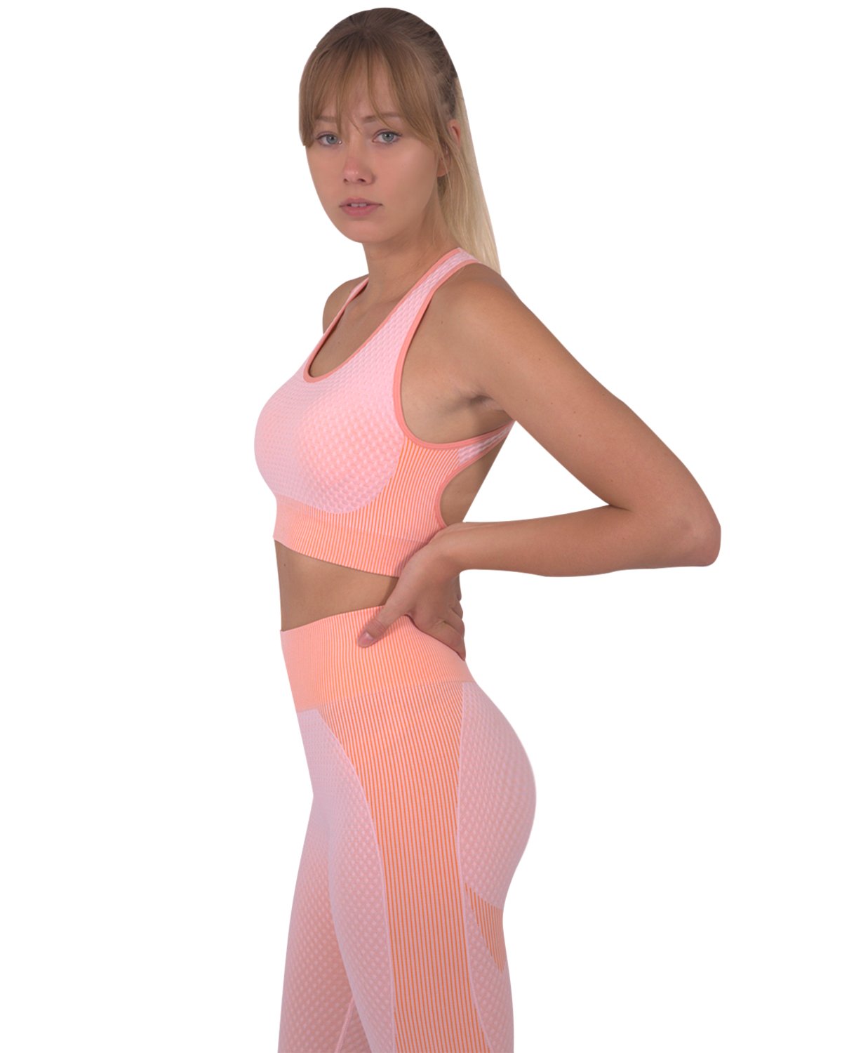 Trois Seamless Sports Bra in pink with orange stripes and cross-over back straps, showcasing its unique design and stylish appearance.