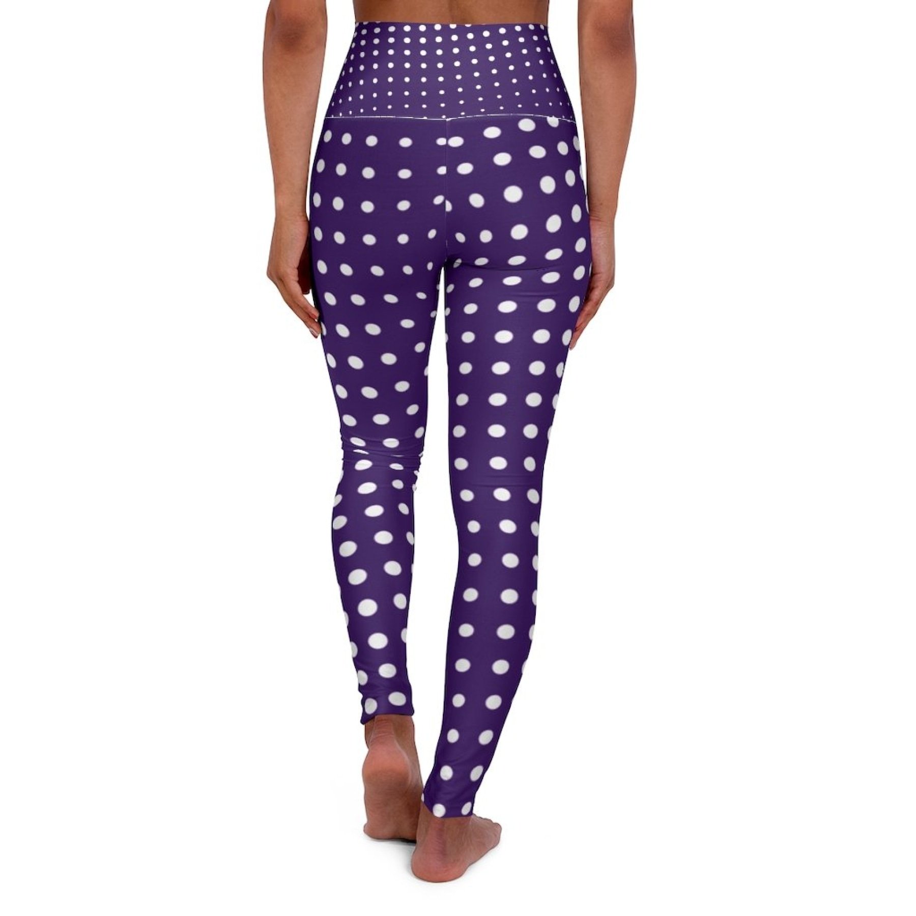 Women's high-waist fitness leggings in purple with white polka dots, designed for comfort and style during workouts.