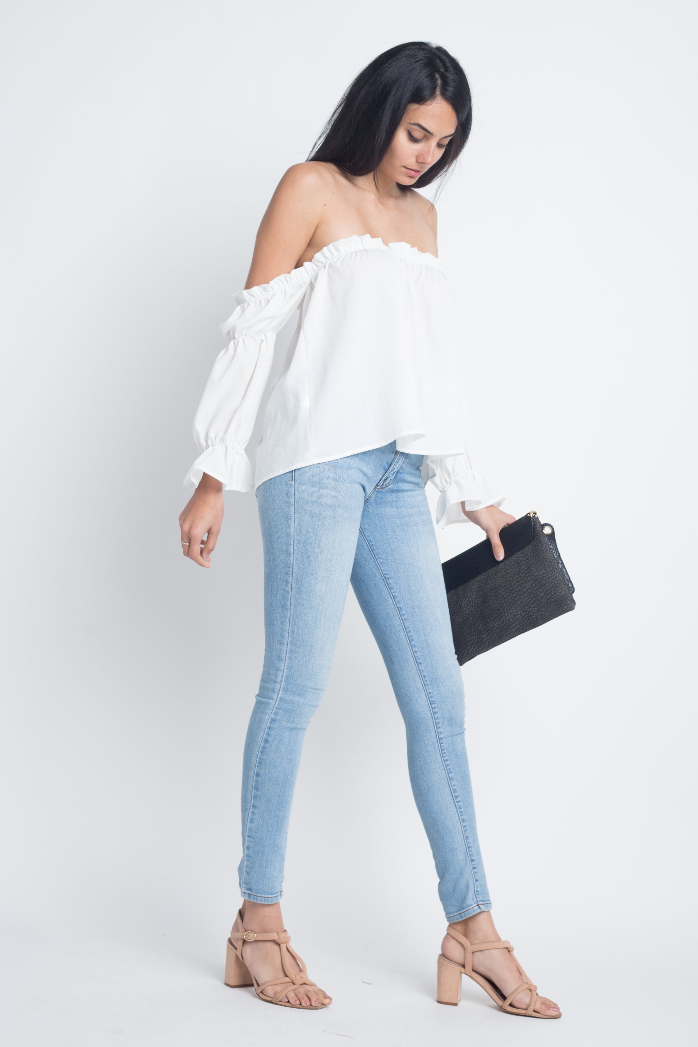 Woman in white blouse, jeans.