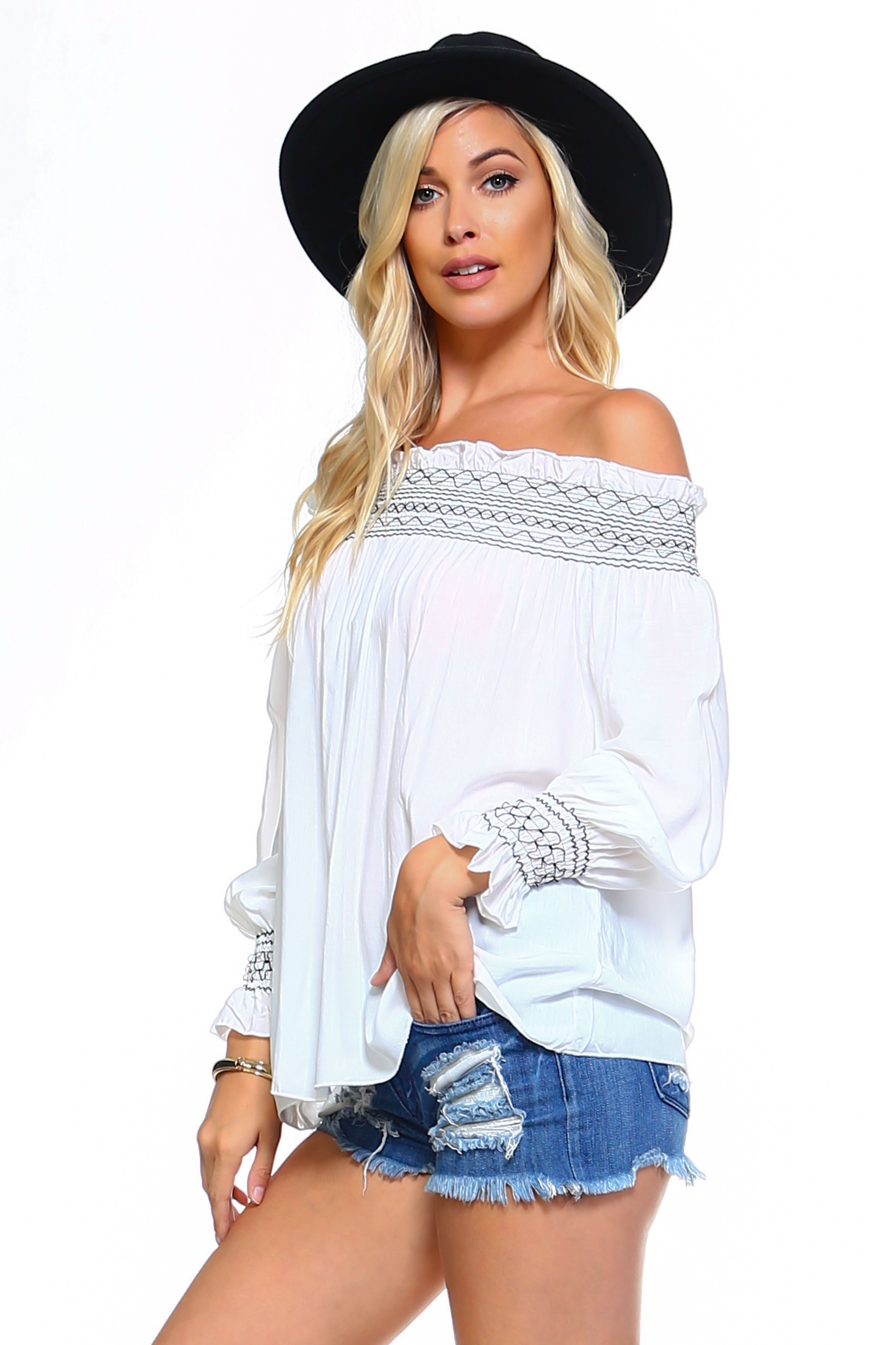 A stylish Women's Off Shoulder Stripe Smocked Elastic Top featuring a smocked design, perfect for summer outings, paired with jean shorts.