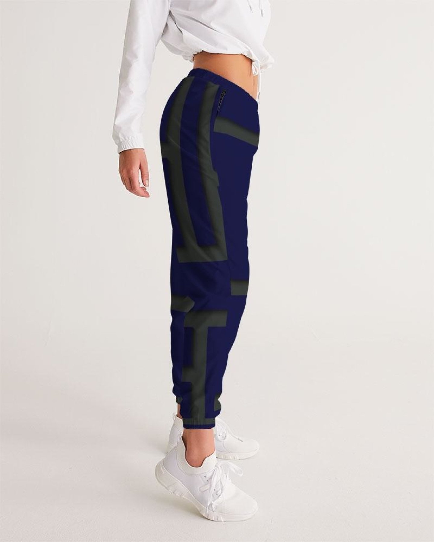 Womens track pants in blue and green geometric graphic, showcasing lightweight and water-resistant fabric with zip pockets.