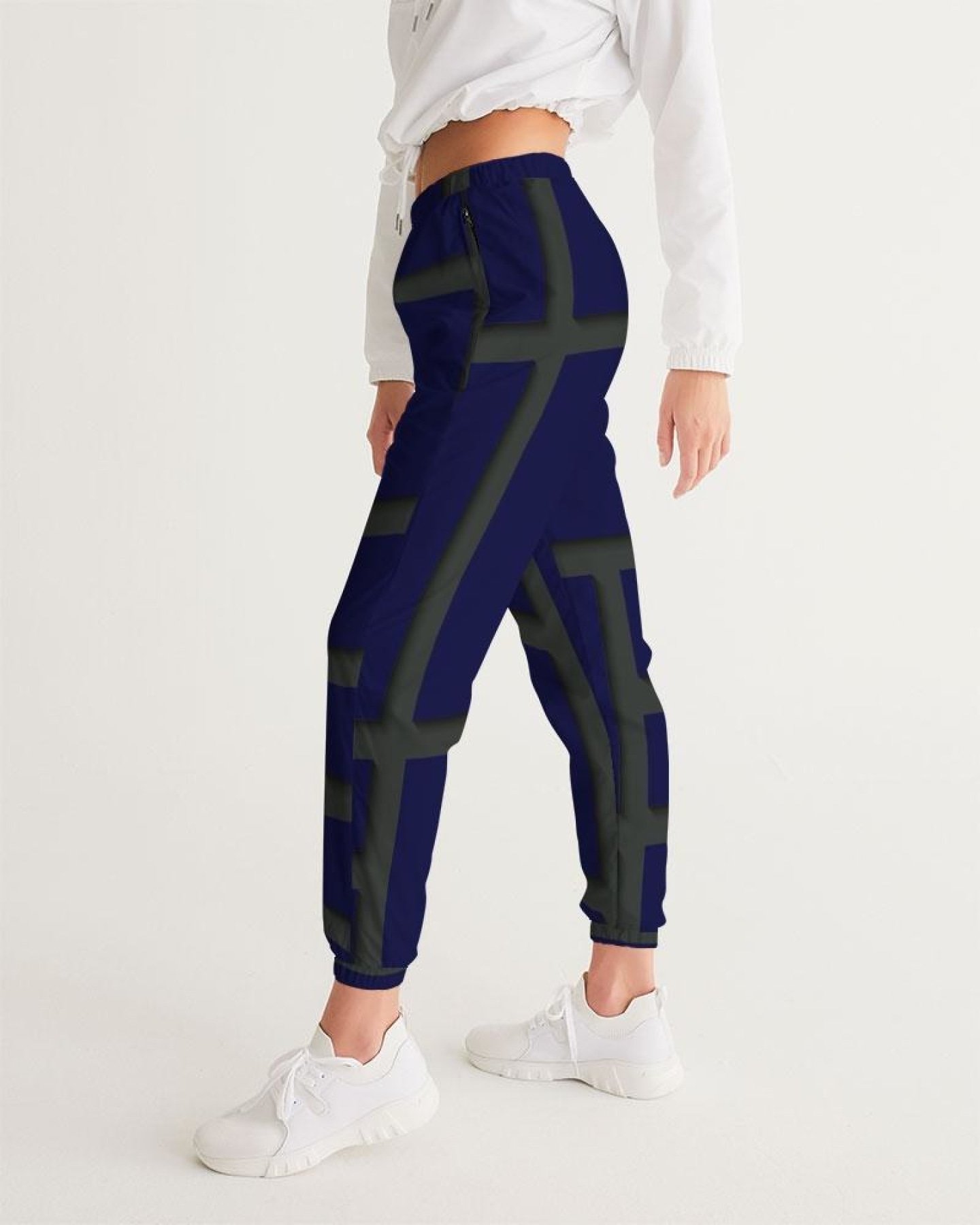 Womens track pants in blue and green geometric graphic, showcasing lightweight and water-resistant fabric with zip pockets.