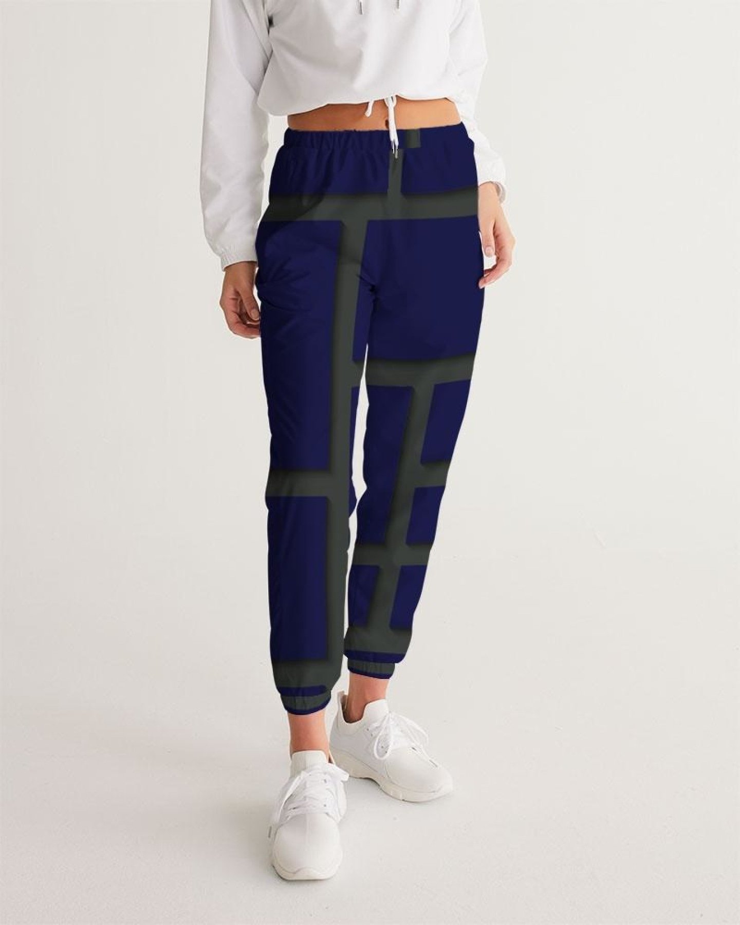 Womens track pants in blue and green geometric graphic, showcasing lightweight and water-resistant fabric with zip pockets.