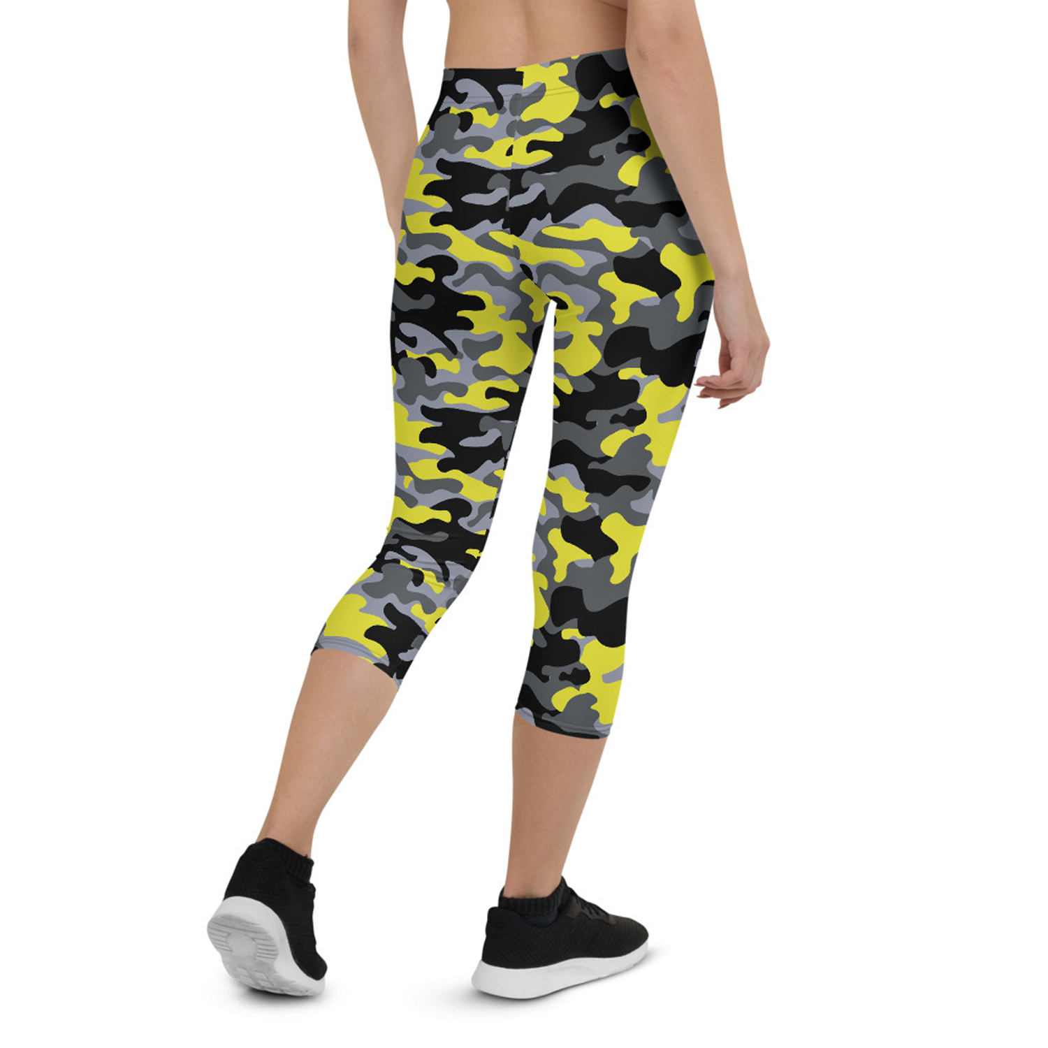 A pair of women's yellow and gray camo capri leggings, showcasing a unique design with a comfortable fit, perfect for workouts and casual wear.