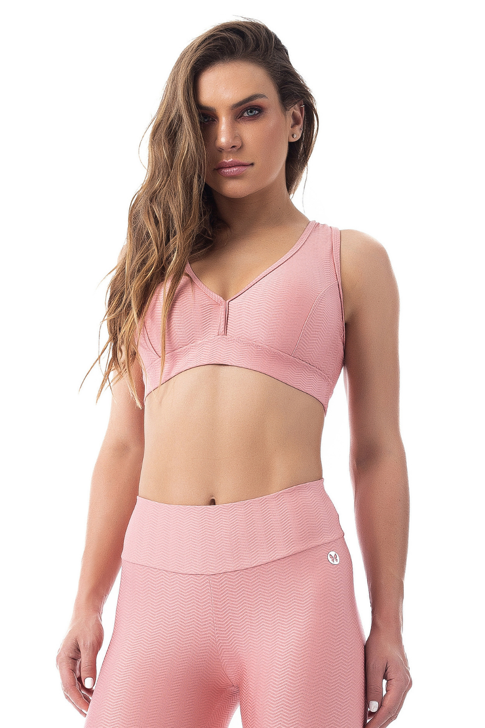 Zilu Sports Bra in blush color with ribbed fabric, featuring an open back and low v-neck design.